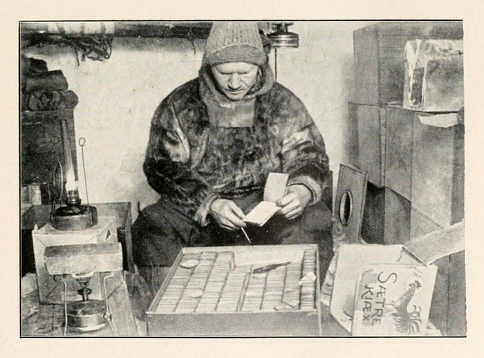 A photo taken by Roald Amundsen of Johansen packing biscuits